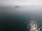 aerial view of ships navigating through foggy conditions.