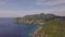 Aerial view ships sailing in blue sea and green mountain landscape. Drone view sailing ships in sea and rocky cliff on