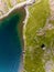 Aerial view of the shoreline of a beautiful mountain lake surrounded by hiking trails on Snowdon, Wales Llyn Glaslyn and the