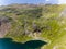 Aerial view of the shoreline of a beautiful mountain lake surrounded by hiking trails on Snowdon, Wales Llyn Glaslyn and the