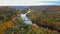 Aerial View of the Sigulda Bridge and Cable Car Over Gauja River During Golden Autumn Season in Latvia.