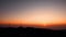 Aerial view of silhouette mountains and windmill during sunset