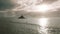 Aerial view of silhouette of person paddling on paddle board with Mokolii Island