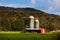 Aerial view of silo towers in background of mountain with dense autumn trees in New Hampshire