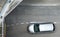 Aerial view of silver car in airport with copy space. Top view of vehicle on street