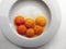 Aerial view of six egg yolks on a white plate