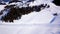 Aerial view of the ski lift at the foot of the ski slope with a crowd of skiers and snowboarders. Alps Austria