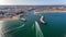 Aerial view from the sky of the Portuguese coastline of the Algarve zone of Lagos city. Boats and ships are moving in