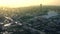 Aerial view of skyscraper, beautiful city during sunset and the river. Stock footage. Golden sky above the houses and