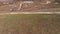 Aerial view of a slow forward movement in a valley above an old building with snow