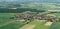 Aerial view from a small airplane from a village near Braunschweig with fields, meadows, farmland and small forests in the area