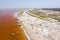 Aerial view of the small boats for salt collecting at pink Lake Retba or Lac Rose in Senegal. Photo made by drone from above.