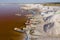 Aerial view of the small boats for salt collecting at pink Lake Retba or Lac Rose in Senegal. Photo made by drone from above.