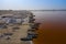 Aerial view of the small boats for salt collecting at pink Lake Retba or Lac Rose in Senegal. Photo made by drone from above.