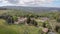 Aerial view of small farm or hotel between picturesque meadows in Tuscany region in sunny summer day