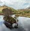 An aerial view the small forested island and southern shore of Loch Eilt, Scotland