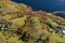 Aerial view of a small homestead and colorful autumn forest