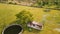 Aerial view of a small house and a tree in the middle of green agriculture fields near Chennai, India.