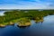 Aerial view of of small islands on a blue lake Saimaa. Landscape with drone. Blue lakes, islands and green forests from above on a