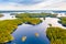 Aerial view of of small islands on a blue lake Saimaa. Landscape with drone. Blue lakes, islands and green forests from above on a