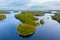 Aerial view of of small islands on a blue lake Saimaa. Landscape with drone. Blue lakes, islands and green forests from above on a