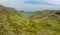 Aerial view of a small lake in a rugged mountain pass