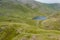 Aerial view of a small lake in a rugged mountain pass Styhead Pass