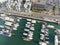 aerial view of small marina with superyachts and smaller leisure vessels moored