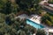 Aerial view of small rectangle swimming pool in olive trees, Italy, travel vacation concept