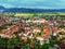 Aerial view of the small Romanian town of Rasnov in the Carpathian valley. Beautiful panorama of the village with red roofs on the