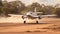 An aerial view of a small, single-engine plane gracefully touching down on a dusty dirt road amongst open fields, Small prop plane