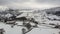 aerial view of a small snowy town with a school and a church