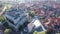 Aerial view of small Spanish township of Simancas overlooking brownish tiled roofs of residential buildings, modern