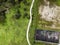 Aerial view of a small walkway trail going offroad in the wood in Monsanto national park on the hill, Lisbon, Portugal