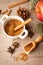 Aerial view of small white bowl with brown sugar, red royal gala apple with cinnamon sticks and autumn leaves, with selective focu