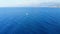 Aerial view on small white yacht sail in blue sea