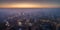 Aerial view of the smog over the waking city at dawn, buildings covered with fog and smog