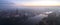 Aerial view of the smog over the waking city at dawn, in the distance buildings covered with fog and smog