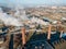 Aerial view smoke clouds from boiler pipes on heating plant in city