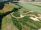 Aerial view on snake shape dirt racetrack for off road vehicles, rural surroundings