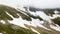 Aerial view of the snow in a canyon high in the Alpine mountains