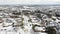 Aerial view snow covered residential houses with downtown skyline in distance background near Dallas, Texas, America