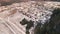 Aerial view of a snow-covered village at the edge of the forest.