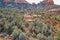 Aerial view of a snow melt waterfall cascading down a red rock cliffside in Sedona, Arizona