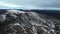 an aerial view of a snowy mountain range with a lake in the middle