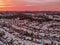 Aerial view of a snowy town under a dusk sky