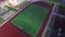 Aerial view soccer players playing football on green field in school yard