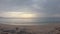 Aerial view soft clouds rainy clouds at the sunset beach. people relaxing on the sandy beach in the summer rainy season. panoramic