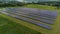 Aerial view of Solar Panels Farm solar cell with sunlight. Drone flight over solar panels field, renewable green