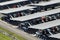 Aerial view of solar panels installed as shade roof over parking lot with parked cars for effective generation of clean